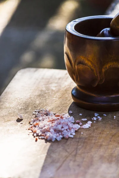 Thick grains of hymalayan salt and the pestle to grind it