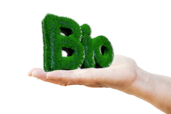Hand van een vrouw met het schrijven "Bio" geschreven met 3d met gras begroeide letters — Stockfoto