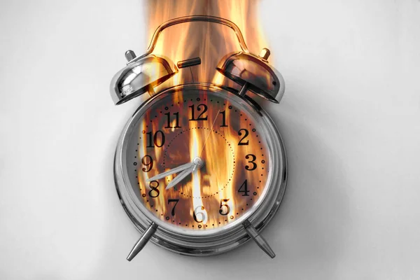 Alarm clock is burning with fire flames — Stock Photo, Image