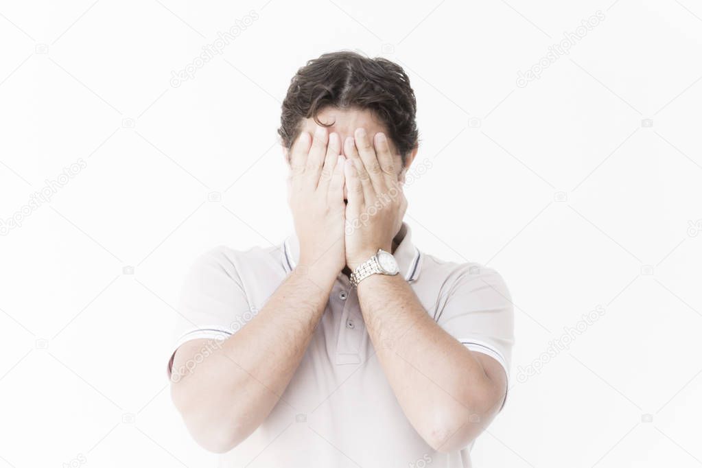 Man keeps the hands in front of his face