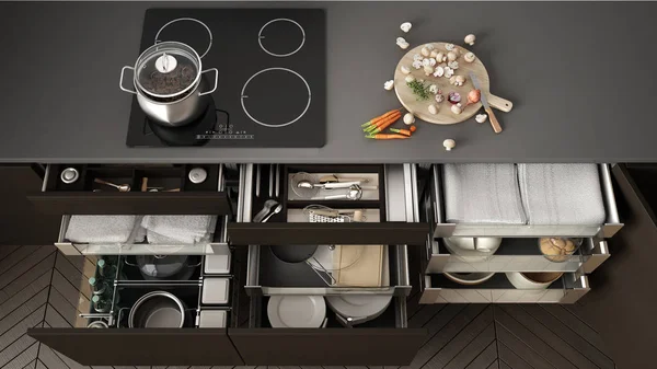 Opened wooden kitchen drawer with accessories inside, solution f