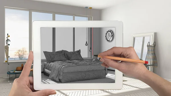 Hands holding and drawing on tablet showing modern bedroom sketc