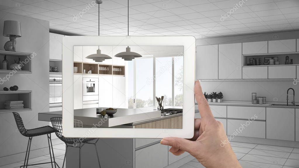 Hand holding tablet showing real finished modern kitchen with is