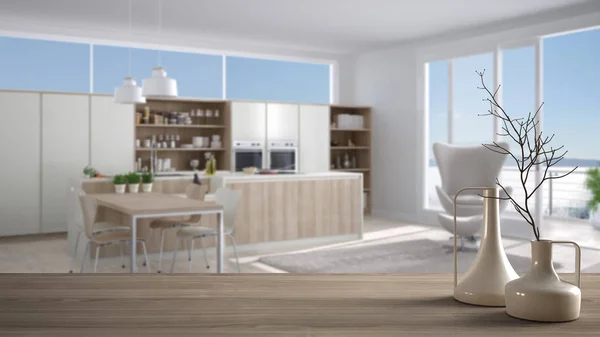 Tavolo o mensola in legno con vasi moderni minimalisti sopra la cucina moderna sfocata con poltrona, design interno bianco — Foto Stock