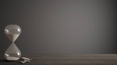 Ahşap masa, masa ya da geri sayım için bir son tarih ve ev anahtarları, karanlık kopya alan arka plan içinde geçen süre ölçümünü kristal modern kum saati ile raf