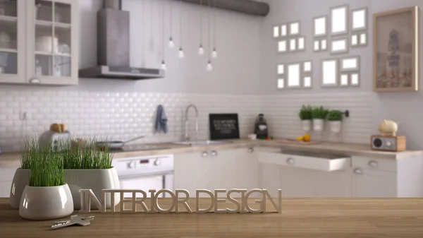 Wooden table, desk or shelf with potted grass plant, house keys and 3D letters making the words interior design, over blurred scandinavian kitchen, project concept copy space background — Stock Photo, Image