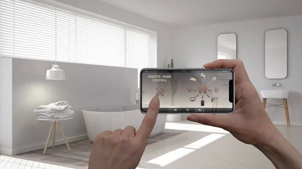 stock image Remote home control system on a digital smart phone tablet. Device with app icons. Interior of minimalist white bathroom in the background, architecture design.