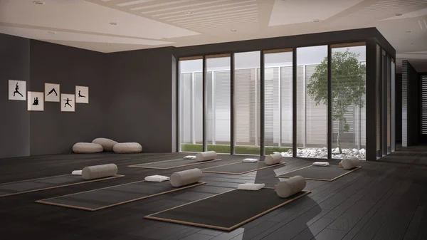 Empty yoga studio interior design, open space with mats, pillows and accessories, parquet, patio house, inner garden with tree and pebbles, ready for yoga practice, meditation room