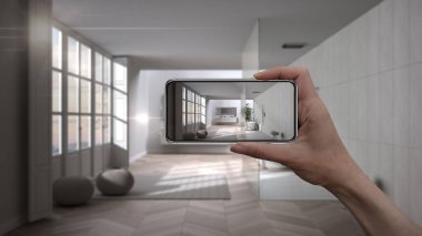 El ele tutuşan akıllı telefon, AR uygulaması, gerçek evdeki mobilya ve iç tasarım ürünleri, mimar tasarım konsepti, bulanık arka plan, küvetli minimalist banyo