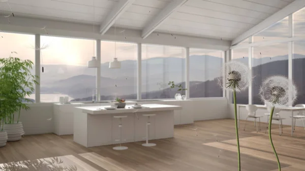 Fluffy airy dandelion with blowing seeds spores over modern white kitchen with island and panoramic windows. Interior design idea. Change, growth, movement and freedom concept