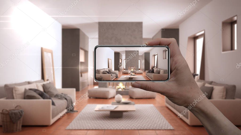 Hand holding smart phone, AR application, simulate furniture and interior design products in real home, architect designer concept, blur background, cosy living room with sofa