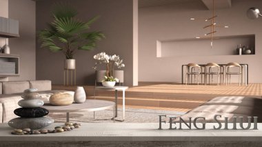 Çakıl taşı dengeli beyaz masa rafı ve 3 boyutlu harflerle oturma odasının üzerinde feng shui kelimesi bej tonlarında ahşap detaylar, zen konsepti iç tasarım.
