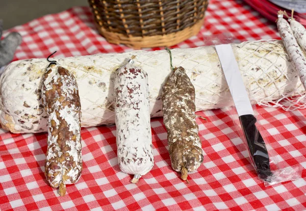 Dried sausage salami in a white packaging