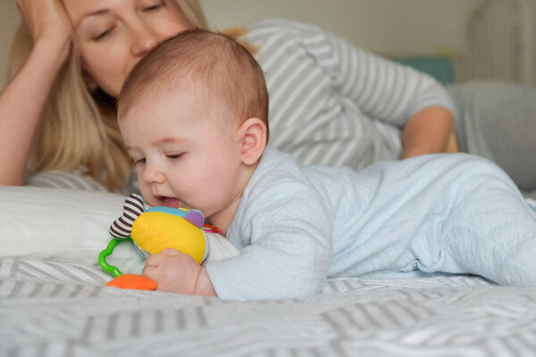 Mother looks at the child as he plays