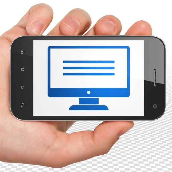 Web development concept: Hand Holding Smartphone with Monitor on display — Stock Photo, Image