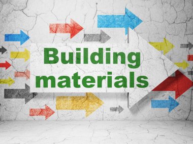 İnşaat kavramı: grunge duvar arka plan üzerinde yapı malzemeleri ile ok