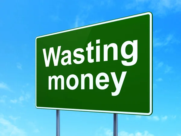 Money concept: Wasting Money on road sign background