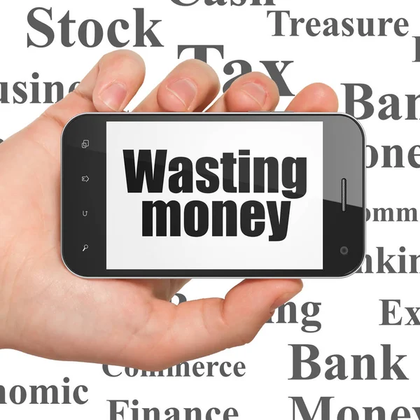 Valuta concept: Hand Holding Smartphone met verspillen van geld op display — Stockfoto