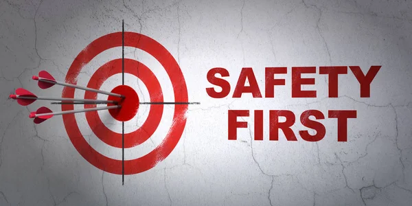 Security concept: target and Safety First on wall background — Stock Photo, Image