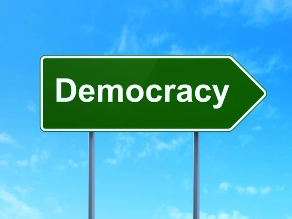 Koncepcja polityki: demokracji na tle znak drogowy — Zdjęcie stockowe