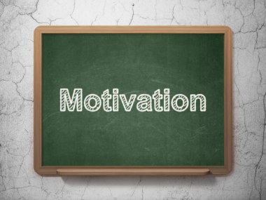 Ekonomi kavramı: motivasyon kara tahta arka plan üzerinde