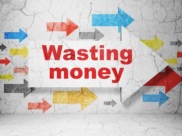 Concepto de moneda: flecha con Wasting Money sobre fondo de pared grunge — Foto de Stock