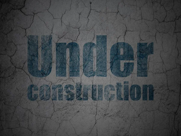 Web utvecklingskoncept: Under Construction på grunge vägg bakgrund — Stockfoto