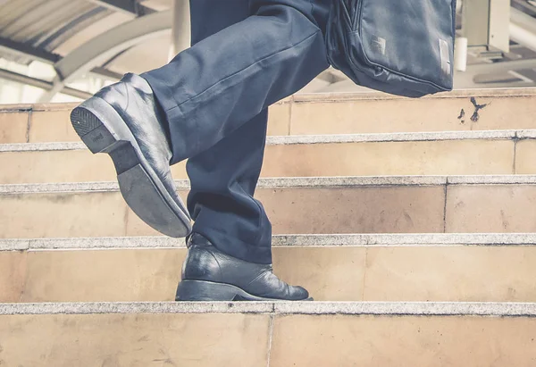 Businessman walking the stairs with city background, Businessmen go to success concept.