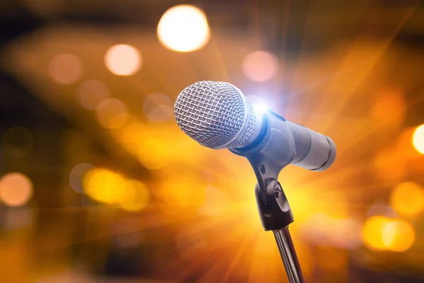 microphone in concert hall, restaurant or conference room blurred background.