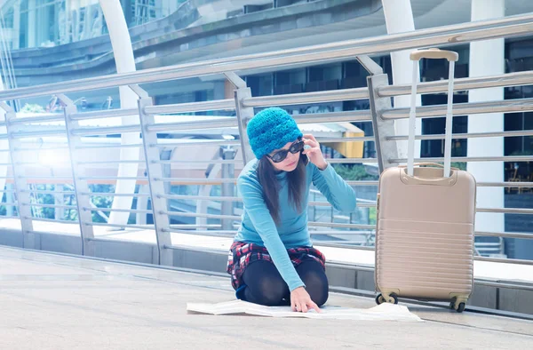 Turystów dziewczyna azjatyckich wyszukiwanie lokalizacji na mapie przewodnik i inteligentny telefon z lotniska w tle — Zdjęcie stockowe
