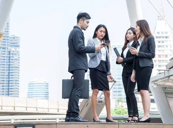 Group of business people talking with mobile phone or tablet, Meeting Communication Discussion Working Concept