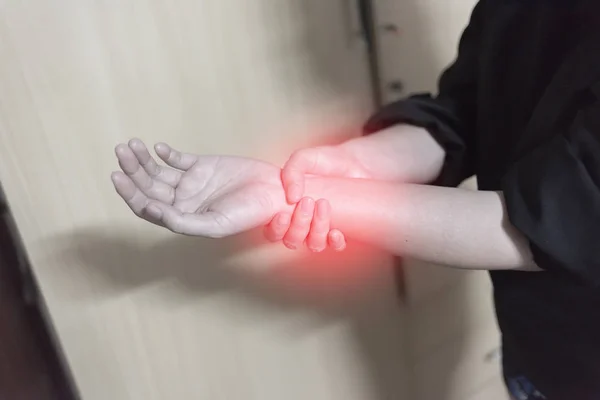 Close up woman holding her wrist symptomatic Office Syndrome, Pain symptoms concept. — Stock Photo, Image