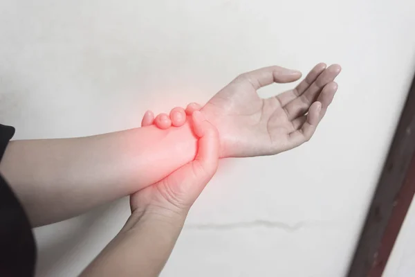 Close up woman holding her wrist symptomatic Office Syndrome, Pain symptoms concept. — Stock Photo, Image