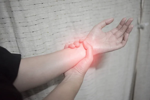 Close up woman holding her wrist symptomatic Office Syndrome, Pain symptoms concept. — Stock Photo, Image