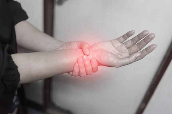 Close up woman holding her wrist symptomatic Office Syndrome, Pain symptoms concept. — Stock Photo, Image