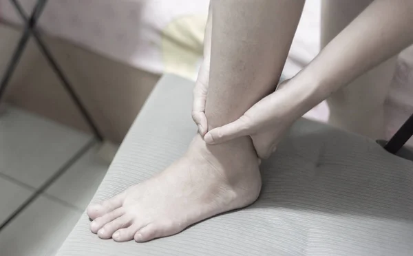 sport injury concept, woman suffering from an ankle injury while exercising and running.