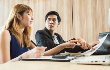 İşadamı ve kadınların çalışma içinde yazıhane labtop ve grafik belge kavramı ile.