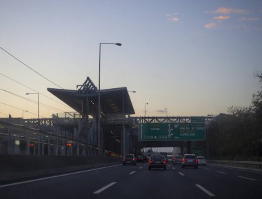 Periferiaki Imittou, Papagos Cholargos, Athens, Greece. December 20, 2019: Cars drive on the autobahn in the Greek capital on a winter evening at sunset