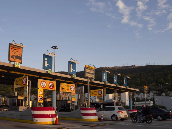 Central Greece. December 2019: Trip on the toll highway Athens-Thessaloniki, past cars, gas stations, toll checkpoints at sunset in the summer evening