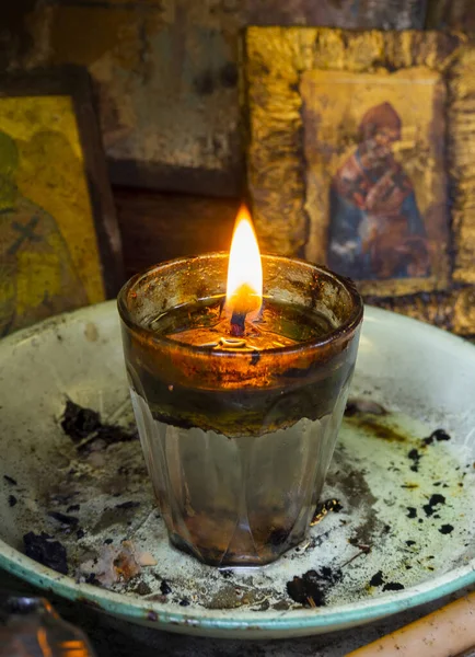 Candelakia - traditional miniature Church by the road in the forest with a burning candle and icons inside on island Evia in Greece