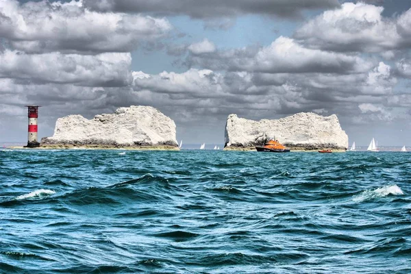 Red and white striped lighthouse at the needles — Stock Photo, Image