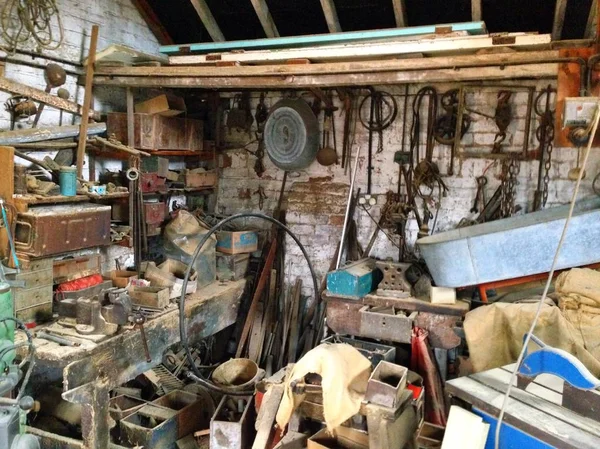 An old workshop full of tools hanging on the wall