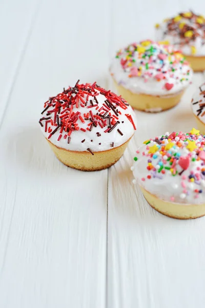 Cupcakes fehér krém és hinti a fehér háttér — Stock Fotó