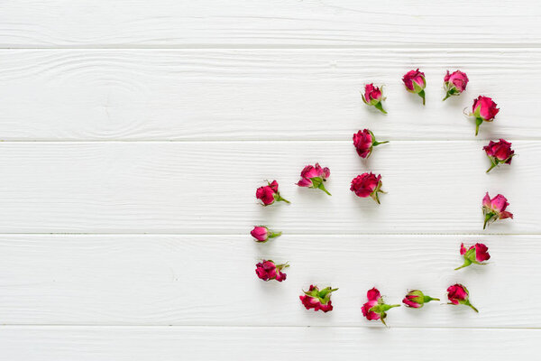 Flowers composition. Pink roses on white wooden background 