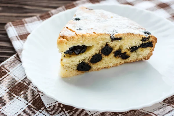 Pastel de cereza espolvoreado azúcar en polvo sobre fondo de madera — Foto de Stock