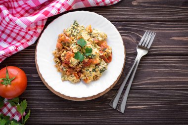 Kızarmış yumurta koyu ahşap masa üzerinde domates ile 