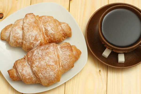 Fresh croissant with coffee on wood — Stock Photo, Image