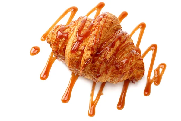 Jeden čerstvý croissant s karamelovou polevou izolované na bílém pozadí — Stock fotografie