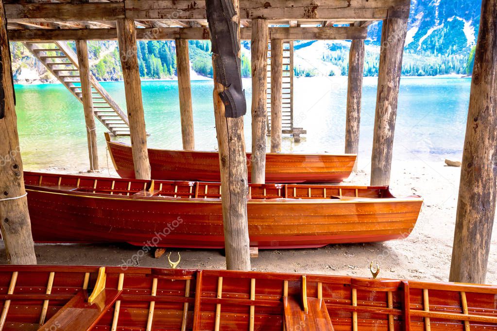 Wooden boats under boat house on Braies lake