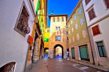 Town gate and colorful architecture of Udine clipart